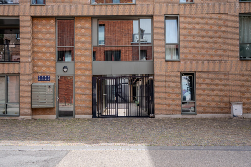 Moderne stalen poort met donkerblauwe afwerking